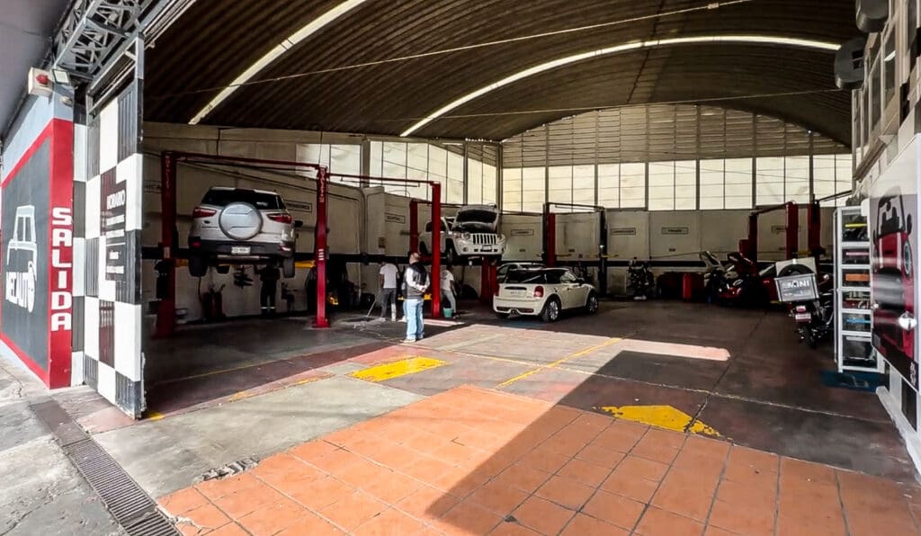 A car repair shop during the day and a taco stand at night.